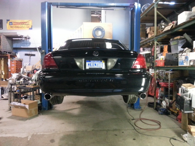 Black 2004 Mercury Grand Marquis rear view on a lift, Michigan license plate MKRM4TT