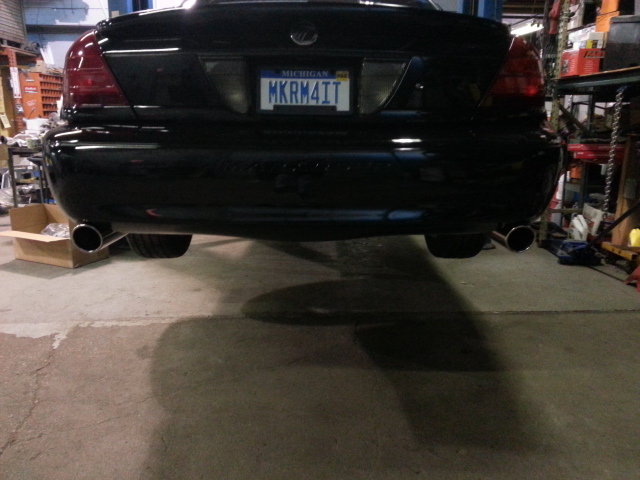 Black 2004 Mercury Grand Marquis rear with dual exhaust and Michigan plate MKRM4IT
