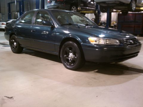 1998 Toyota Camry - This 1998 Toyota Camry sedan is shown from the front quarter angle inside a service garage.