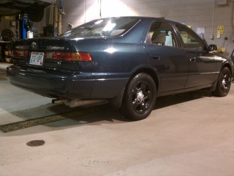 1998 Toyota Camry - This 1998 Toyota Camry sedan is shown from the rear in a garage setting.
