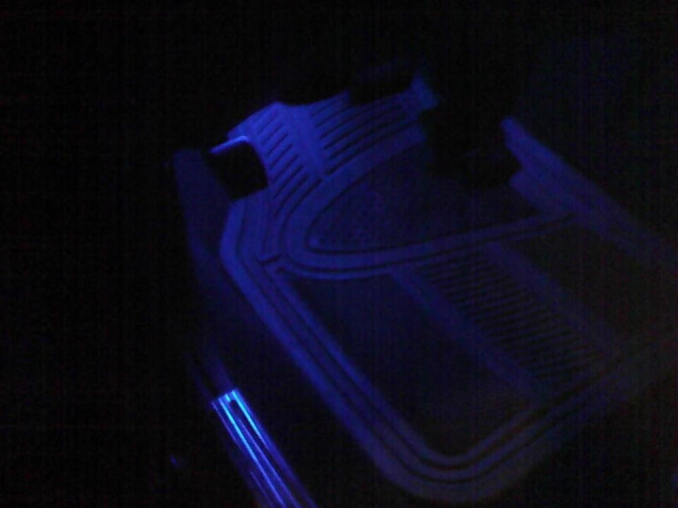 Car floor mats with blue LED lighting strips underneath