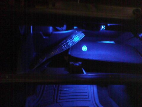 2003 Ford Crown Victoria - The dashboard of a 2003 Ford Crown Victoria is illuminated with blue light, revealing the steering wheel and instrument panel.