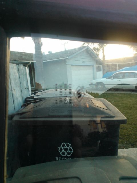 1968 Ford Bronco - Trash cans and a white sedan are visible in a residential driveway scene.