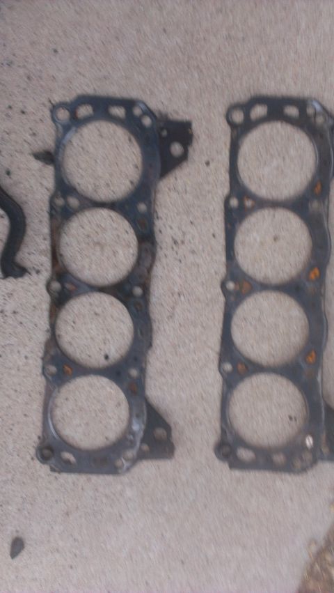 1990 Ford Bronco - Engine gaskets are shown on a concrete surface, with a watermark at the bottom.