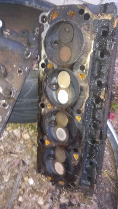 1990 Ford Bronco - This is a used engine cylinder head, showing multiple valves and combustion chambers.