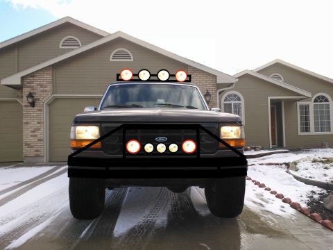 1992 Ford Bronco - This Ford truck features an aggressive aftermarket bumper and auxiliary lights on the roof and grille.