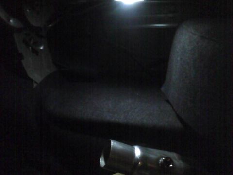 2003 Ford Crown Victoria - The interior of a vehicle is shown, with a metal pipe visible in the foreground.