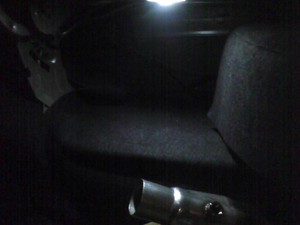 Interior view of a car with a metal pipe in the foreground