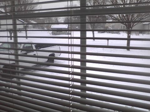 2003 Ford Crown Victoria - A white pickup truck is visible through blinds on a snowy day.