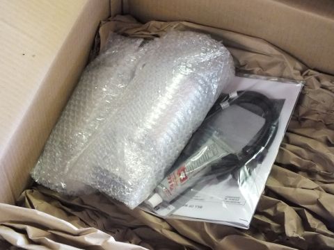 2003 Ford Crown Victoria - Bubble-wrapped exhaust component with cabling, hardware tube, and paperwork packed in kraft paper.