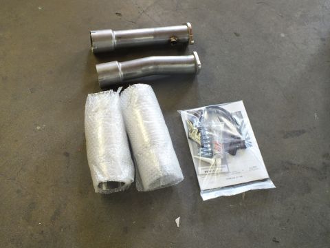 2003 Ford Crown Victoria - Two stainless tubes, two bubble-wrapped components, and a hardware kit arranged on concrete.