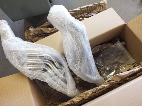 2003 Ford Crown Victoria - Pair of header assemblies in bubble wrap with bagged fittings packed beside them in a box.