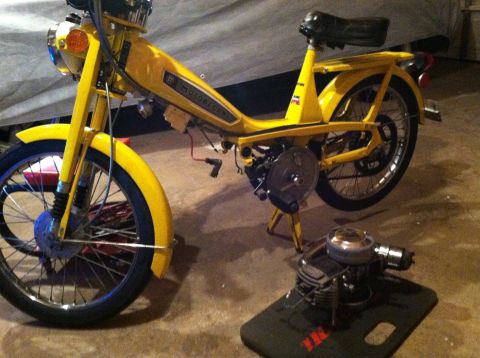1981 Garelli Rally Sport - Yellow moped with "Motobecane" text on frame, detached engine on mat.