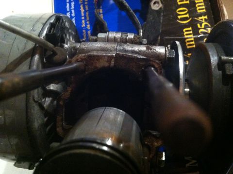 1981 Garelli Rally Sport - A close-up view of an engine component, showing signs of wear and rust, with some text visible on a box in the background.