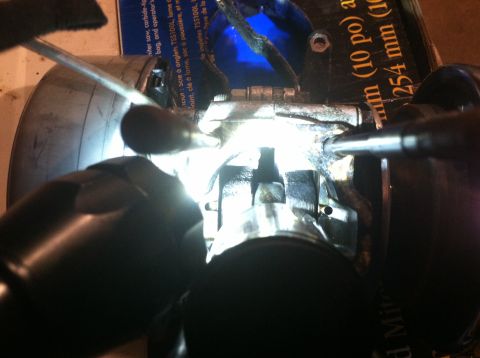 1981 Garelli Rally Sport - Mechanic working on an engine crankshaft with tools.