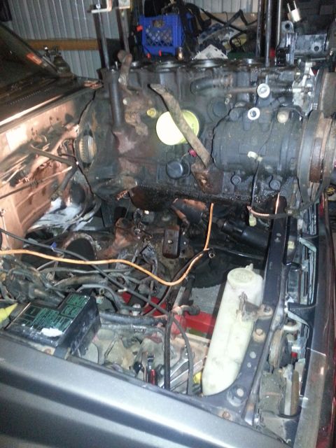 1987 Toyota 4Runner - Vehicle engine bay with engine undergoing removal or installation.