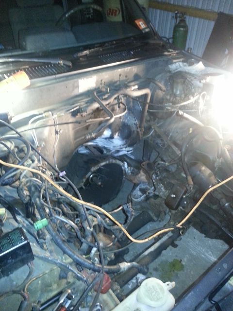 1987 Toyota 4Runner - The engine bay of a vehicle is shown with its components exposed and wiring accessible.