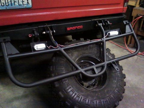 1989 Ford Bronco - Custom rear bumper and swing-down tire carrier on a 1989 Ford Bronco, red 'BRONCO' badging.