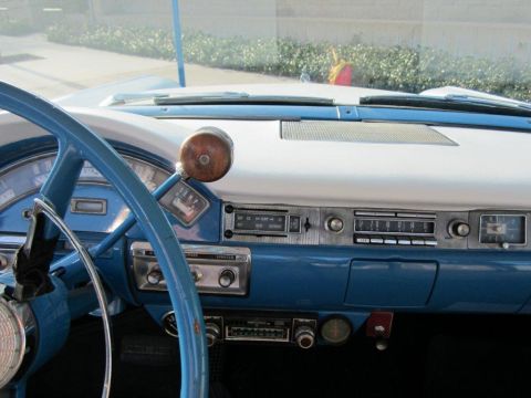 1957 Ford Ranchero - The dashboard features a blue steering wheel and blue and white accents on the dash panel.