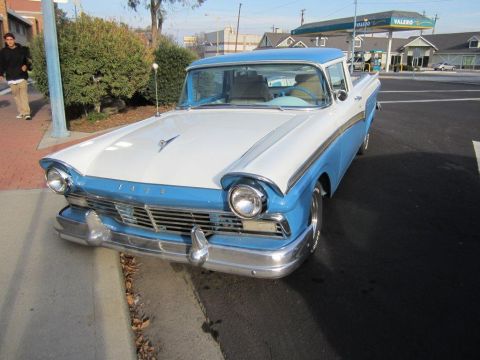1957 Ford Ranchero - A classic two-tone pickup truck is parked curbside on a sunny day.