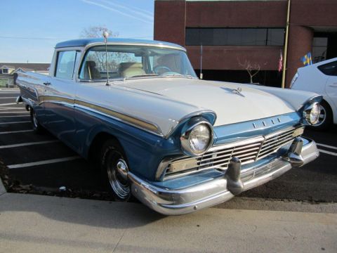 1957 Ford Ranchero - A classic 1957 Ford Ranchero pickup truck is shown from a three-quarter front angle.