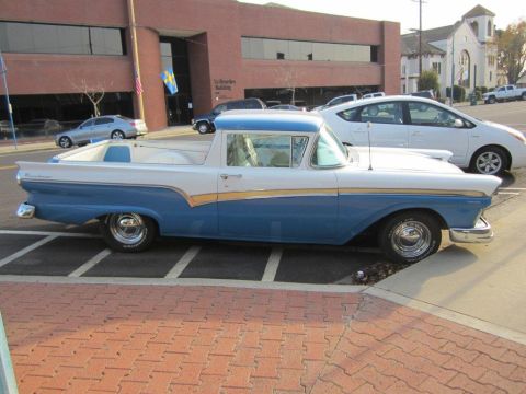 1957 Ford Ranchero - A classic 1957 Ford Ranchero is seen parked on a street, a distinctive two-tone blue and white paint scheme.
