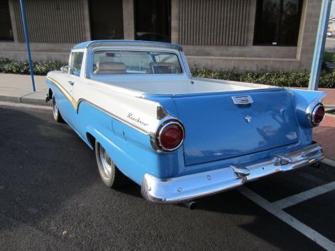 1957 Ford Ranchero - Rear view of a two-tone blue and white 1957 Ford Ranchero parked on asphalt.