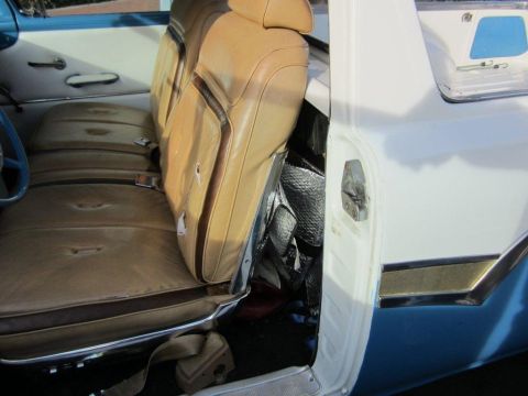 1957 Ford Ranchero - Interior view of a vintage car, showing the tan bench seat and door panel.