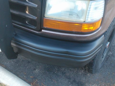 1992 Ford Bronco - Close-up of the front bumper and headlight on a 1992 Ford Bronco.