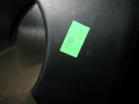 2003 Ford Crown Victoria - A black plastic automotive part is shown with a green sticker containing the number 9980.