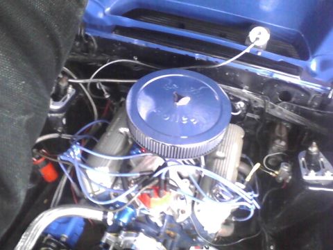 2003 Ford Crown Victoria - Close-up view of a car's engine bay with various components visible.