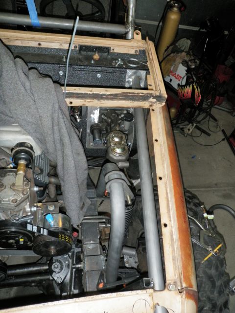 1961 International Scout 800 - Close-up of an engine bay, focusing on the brake master cylinder and surrounding components with a roll cage structure.