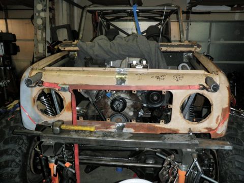 1961 International Scout 800 - The front end of a 1961 International Scout 800 is visible, with the engine compartment open and some body damage.