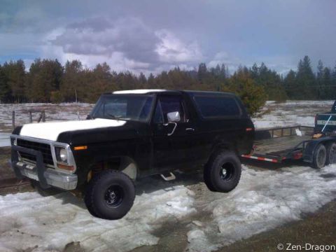 1994 Ford Bronco - This 1978 Ford Bronco is black with a white hood and is towing a trailer.