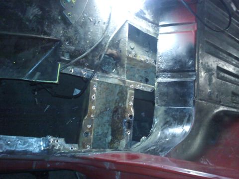1978 Ford Bronco - The interior of a vehicle shows significant rust and damage, with evidence of recent welding.