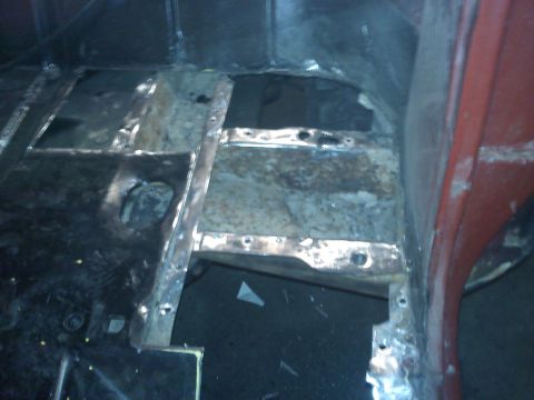 1978 Ford Bronco - The interior floor pan of a vehicle shows significant rust and has been cut open for repairs.