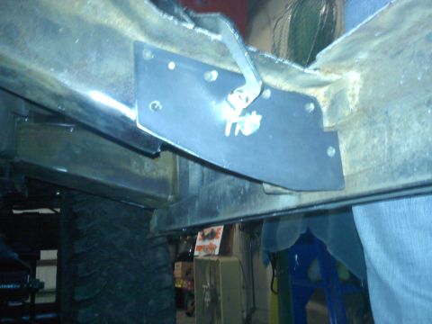 1978 Ford Bronco - Close-up view of a metal plate attached to the underbody chassis, with some text visible on the plate.