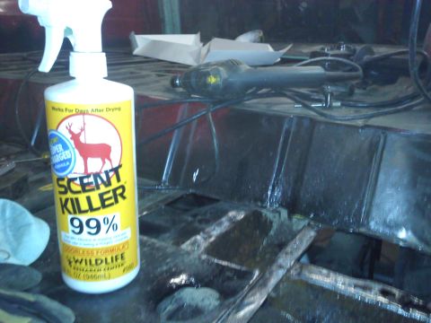 1978 Ford Bronco - A bottle of Scent Killer is placed on a surface with tools, suggesting preparation or cleaning.