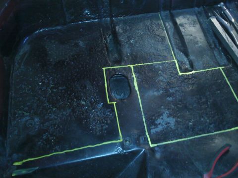 1978 Ford Bronco - The interior floor of a vehicle is marked with yellow tape, indicating areas for modification.