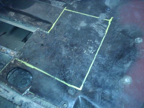 1978 Ford Bronco - Metal floor panel marked with yellow lines for cutting, showing signs of rust and fasteners.