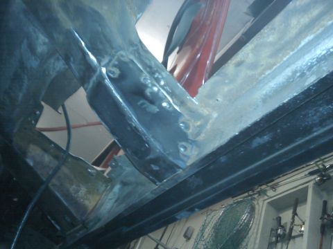 1978 Ford Bronco - Close-up view of a vehicle's undercarriage, showing structural components and signs of wear.