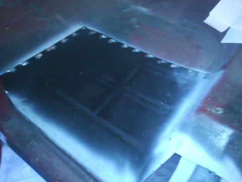 1978 Ford Bronco - A section of metal with a hole cut out, possibly for a component, with a watermark at the bottom right.