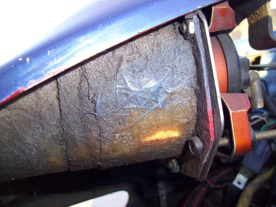 Close-up of an engine component with wiring and orange accents