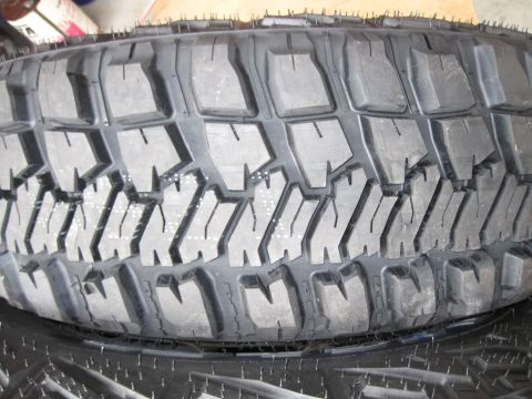 1992 Ford Bronco - A close-up view of a tire's tread pattern is shown, with no vehicle visible.