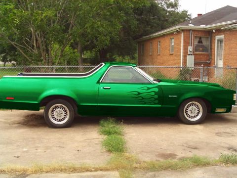 1994 Ford Bronco - This green El Camino features flame decals on its side and a distinctive body style.