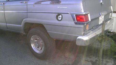 1982 Jeep Wagoneer - The rear of a silver Jeep Wagoneer shows its "Wagoneer" badging and chrome accents.
