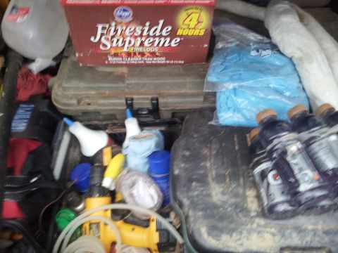 1986 Ford Bronco - The cargo area is filled with various items including a box of Fireside Supreme firelogs, tools, and several bottles of Gatorade.