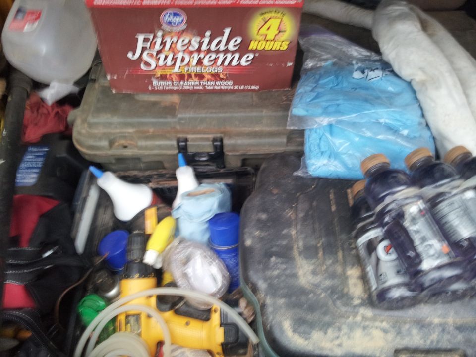Interior cargo area with firelogs, tools, and drinks