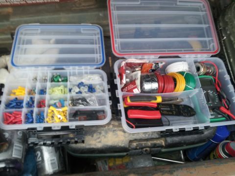1986 Ford Bronco - Organized storage boxes contain electrical supplies and tools for automotive repairs.