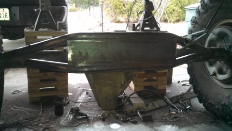 1967 Ford F-250 - Truck rear axle assembly undergoing maintenance or modification, supported by blocks and jacks.